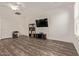 Living room with wood floors, large TV, minimalist furniture, and bright natural light at 22125 N 29Th Ave # 137, Phoenix, AZ 85027