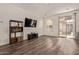 Spacious living room featuring wood floors, neutral walls, and access to a balcony at 22125 N 29Th Ave # 137, Phoenix, AZ 85027