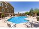 Community pool surrounded by lounge chairs and a meticulously maintained fence and landscaping at 22125 N 29Th Ave # 137, Phoenix, AZ 85027