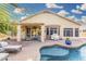 Stunning backyard with a pristine pool, covered patio, and well-manicured landscaping for outdoor enjoyment at 22351 N 67Th Dr, Glendale, AZ 85310