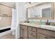 Bathroom with a double vanity, granite countertop, framed mirror, and a shower-tub combination at 22351 N 67Th Dr, Glendale, AZ 85310