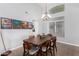 Elegant dining room with a wooden table, six chairs, and a chandelier, perfect for Gathering gatherings at 22351 N 67Th Dr, Glendale, AZ 85310