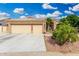 Inviting home with desert landscaping, a spacious driveway, and a convenient two-car garage at 22351 N 67Th Dr, Glendale, AZ 85310