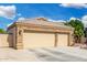 Large two-car garage with a wide driveway and access gate, offering ample parking space at 22351 N 67Th Dr, Glendale, AZ 85310