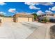 Spacious three-car garage with stone accents and a wide driveway, perfect for extra parking at 22351 N 67Th Dr, Glendale, AZ 85310