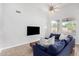 Bright living room with high ceilings, tile floors, and comfortable blue sofa at 22351 N 67Th Dr, Glendale, AZ 85310