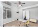 Bright home office featuring a large window, ceiling fan, and modern desk setup, ideal for productivity at 22351 N 67Th Dr, Glendale, AZ 85310
