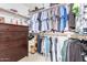 Walk-in closet boasts extensive shelving and hanging space, complemented by a dresser for organized storage at 22351 N 67Th Dr, Glendale, AZ 85310