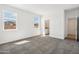 Bedroom with carpet, large window, and entry to the bathroom with dual sinks at 22565 Rummler Ln, Maricopa, AZ 85138