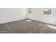 Bedroom featuring carpet, two windows, and ample natural light for a relaxing space at 22565 Rummler Ln, Maricopa, AZ 85138
