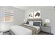 Inviting bedroom featuring a plush bed, neutral tones, and natural light from a bright window at 22565 Rummler Ln, Maricopa, AZ 85138