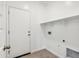 Laundry room with tile floor and shelving offers convenience and ample storage space at 22565 Rummler Ln, Maricopa, AZ 85138