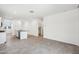 Open-concept space with tile flooring, a kitchen island, and plenty of room for entertaining or relaxing at 22565 Rummler Ln, Maricopa, AZ 85138