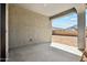 A covered patio offers views of the backyard for relaxing or entertaining outdoors at 22565 Rummler Ln, Maricopa, AZ 85138