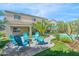 Stunning backyard features a sparkling swimming pool, inviting seating area, and lush landscaping, ideal for relaxation at 23523 N 117Th Dr, Sun City, AZ 85373