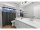 Bright bathroom boasts a double sink vanity, large mirror, and tiled floor, complemented by a shower/tub combo at 23523 N 117Th Dr, Sun City, AZ 85373