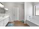 Bright bathroom with double sinks, a soaking tub, and a separate shower at 23523 N 117Th Dr, Sun City, AZ 85373