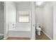 Bright bathroom featuring a tub/shower and a separate water closet at 23523 N 117Th Dr, Sun City, AZ 85373