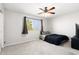 This bedroom features a ceiling fan, carpet, window, and a comfortable bed, creating a cozy and inviting space at 23523 N 117Th Dr, Sun City, AZ 85373