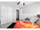 Bedroom featuring wainscotting, a ceiling fan, and closet storage at 23523 N 117Th Dr, Sun City, AZ 85373