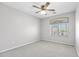 The bedroom features a ceiling fan and large window at 23523 N 117Th Dr, Sun City, AZ 85373