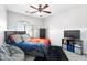 Well-lit bedroom featuring a ceiling fan and a cozy area rug at 23523 N 117Th Dr, Sun City, AZ 85373