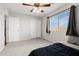 Bright bedroom featuring a ceiling fan, carpet, window, and closet, creating a comfortable and functional space at 23523 N 117Th Dr, Sun City, AZ 85373