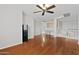Spacious upstairs bonus room featuring hardwood floors, a ceiling fan, and access to the landing at 23523 N 117Th Dr, Sun City, AZ 85373