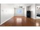 Spacious bonus room featuring hardwood floors, a ceiling fan, a window with blinds, and a black gun safe at 23523 N 117Th Dr, Sun City, AZ 85373
