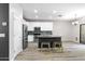 Bright kitchen with white cabinets, stainless steel appliances, and a stylish kitchen island at 23523 N 117Th Dr, Sun City, AZ 85373