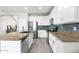 Modern kitchen with stainless steel appliances, granite countertops, white cabinetry, and a kitchen island at 23523 N 117Th Dr, Sun City, AZ 85373