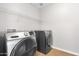 Well-equipped laundry room featuring a modern washer and dryer set and convenient overhead shelving at 23523 N 117Th Dr, Sun City, AZ 85373