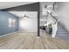 Open living space with wood-look flooring, a stylish staircase and natural light at 23523 N 117Th Dr, Sun City, AZ 85373