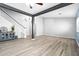 Open-concept living room boasts wood-look tile floors and stylish black support beams at 23523 N 117Th Dr, Sun City, AZ 85373