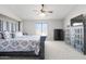 Cozy main bedroom featuring a decorative bed frame and a large window at 23523 N 117Th Dr, Sun City, AZ 85373