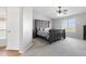 Primary bedroom with a tray ceiling, plush carpeting, a ceiling fan, and ensuite bath access at 23523 N 117Th Dr, Sun City, AZ 85373