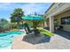Inviting backyard patio with comfortable seating, perfect for outdoor dining and entertaining around the pool at 23523 N 117Th Dr, Sun City, AZ 85373