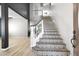 Elegant staircase with decorative tiles, white railing, and an open view of the living room at 23523 N 117Th Dr, Sun City, AZ 85373
