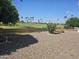 A well-manicured backyard with a golf course in the background and flower bed in the foreground at 2528 N Lema Dr, Mesa, AZ 85215