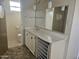 Bathroom featuring a single sink vanity, wall mirror, and adjacent tiled shower stall at 2528 N Lema Dr, Mesa, AZ 85215