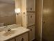 Bathroom featuring a single sink vanity, storage cabinet and wall mirror at 2528 N Lema Dr, Mesa, AZ 85215