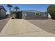 Charming single-story home featuring a well-maintained lawn and cozy covered parking at 2528 N Lema Dr, Mesa, AZ 85215