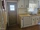 Traditional kitchen featuring white cabinetry, laminate countertops, and a functional layout at 2528 N Lema Dr, Mesa, AZ 85215