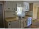 Traditional kitchen featuring white cabinetry, laminate countertops, and a functional layout at 2528 N Lema Dr, Mesa, AZ 85215