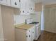 Functional kitchen with white cabinets and appliances; perfect for cooking your favorite meals at 2528 N Lema Dr, Mesa, AZ 85215