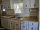 Traditional kitchen featuring white cabinetry, laminate countertops, and a functional layout at 2528 N Lema Dr, Mesa, AZ 85215