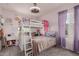 Cute bedroom features a bunk bed with desk and ladder, and a ceiling fan at 2540 N Stone Hill Rd, Buckeye, AZ 85396