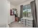 Walk-in closet featuring shelving units, drawers, carpet floors, and a window at 2540 N Stone Hill Rd, Buckeye, AZ 85396