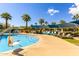 Community pool featuring a chair lift, covered areas, and lounge chairs for residents at 2540 N Stone Hill Rd, Buckeye, AZ 85396