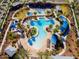 Aerial view of large community pool featuring cabanas, lounge chairs, and palm trees at 2540 N Stone Hill Rd, Buckeye, AZ 85396
